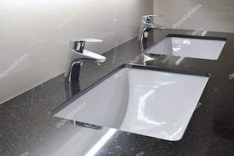 Modern style faucet with black granite counter top