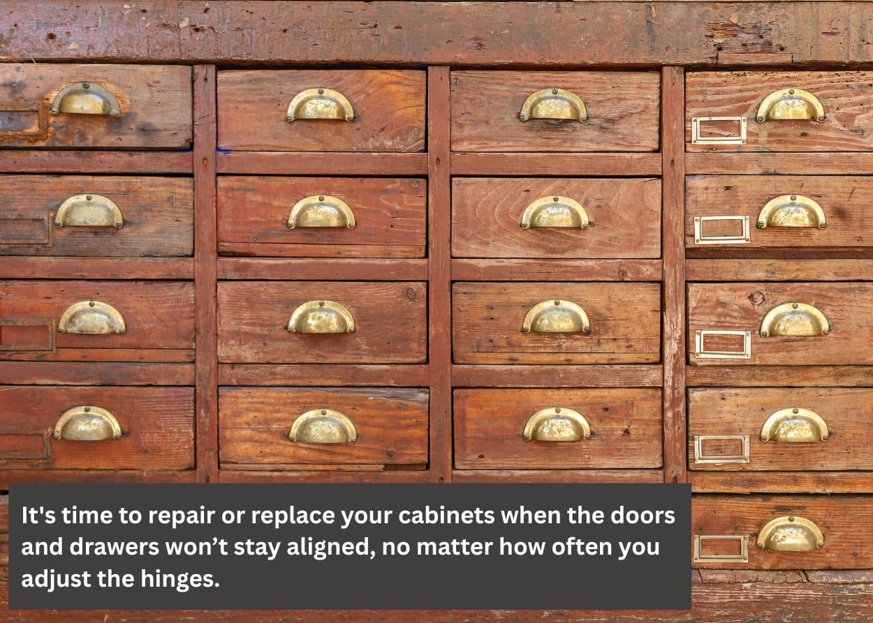Close-up of worn wooden drawers showing signs it may be time to repair or replace bathroom cabinets. Caption: It's time to repair or replace your cabinets when the doors and drawers won’t stay aligned, no matter how often you adjust the hinges.