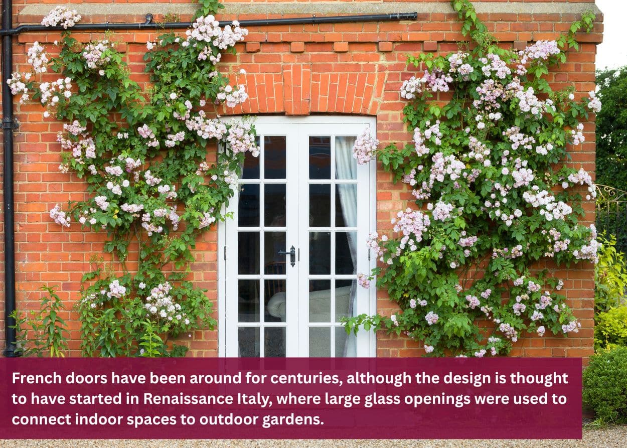 White French patio doors framed by climbing flowering vines on a brick home exterior